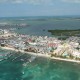 aerial view of boats and houses on narrow stretch of beach in belize