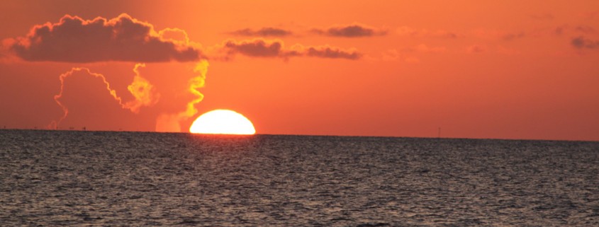 another beautiful sunset in belize while sailing near islands