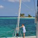 arriving at goff's caye island on luxury catamaran