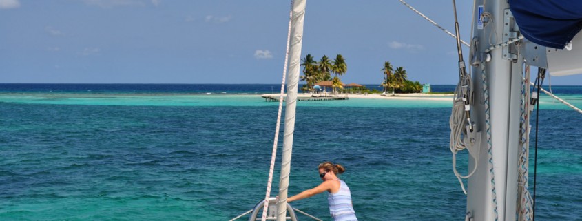 arriving at goff's caye island on luxury catamaran