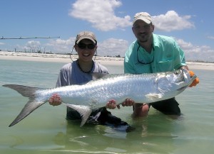 boy holding tarpon after fishing shallows in belize