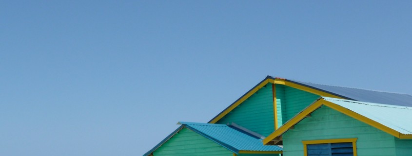 bright green house on water in belize