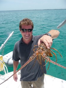 captain cliff holds lobster caught for dinner in belize