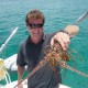 captain cliff holds lobster caught for dinner in belize