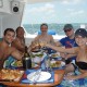 couples toasting wine on catamaran after snorkeling at hol chan