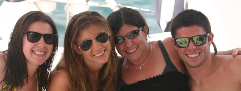 family and friends pose on catamaran charter in beautiful belize