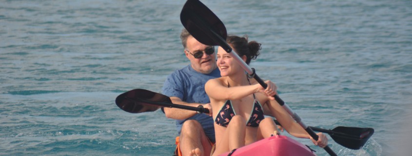 family sea kayaking in belize calm waters