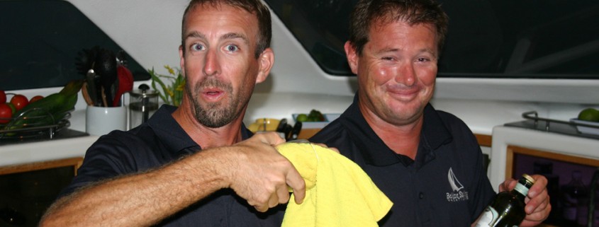 friendly crew of belize sailing vacations mixing cocktails for guests