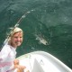 girl poses with fish caught off 50' catamaran sailing in belize