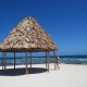 girl relaxing white sand beach hut on remote island while on vacation in belize