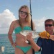 girl shows fish caught while fishing on belize sailing vacations catamaran charter