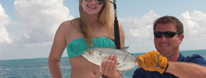 girl shows fish caught while fishing on belize sailing vacations catamaran charter