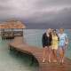 girls pose on dock on remote island in belize