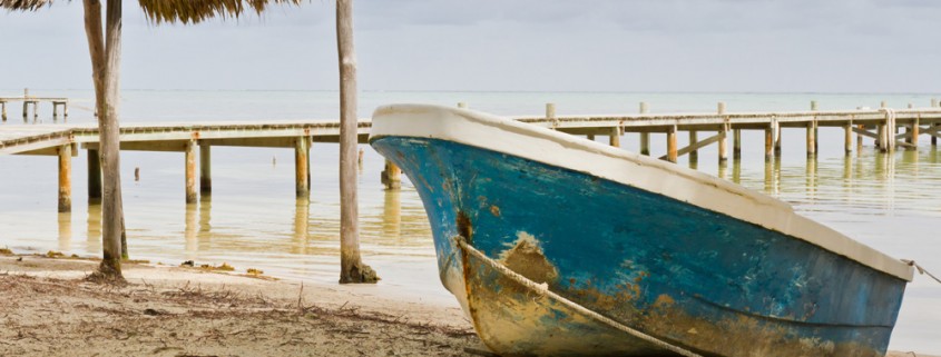 local fishing boat on beach in belize near doc