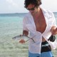 man holding fish caught fly fishing in belize off goff's caye