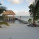 relaxing hut with hammock and long dock off beach in belize while on vacation