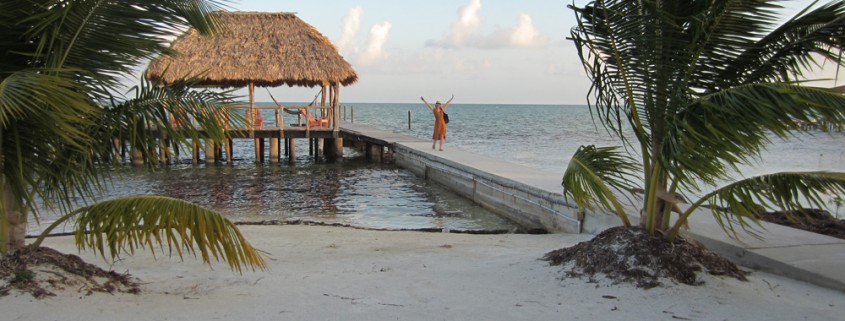 relaxing hut with hammock and long dock off beach in belize while on vacation