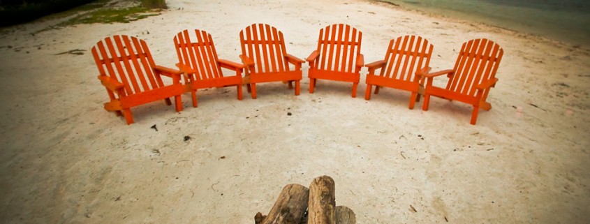 row of chairs near dive resort in belize at sunset