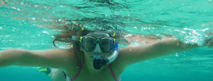 snorkeling girl in belize's clear water shallows