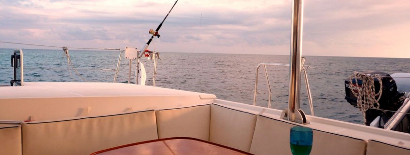 view of outside dining area on catamaran charter in belize's blue waters