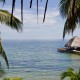 view of tropical paradise and long dock with shaded hut in water