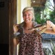 woman holding snake around shoulders while on vacation in belize