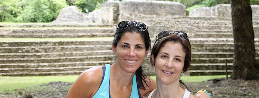 women pose at mayan temple site in belize