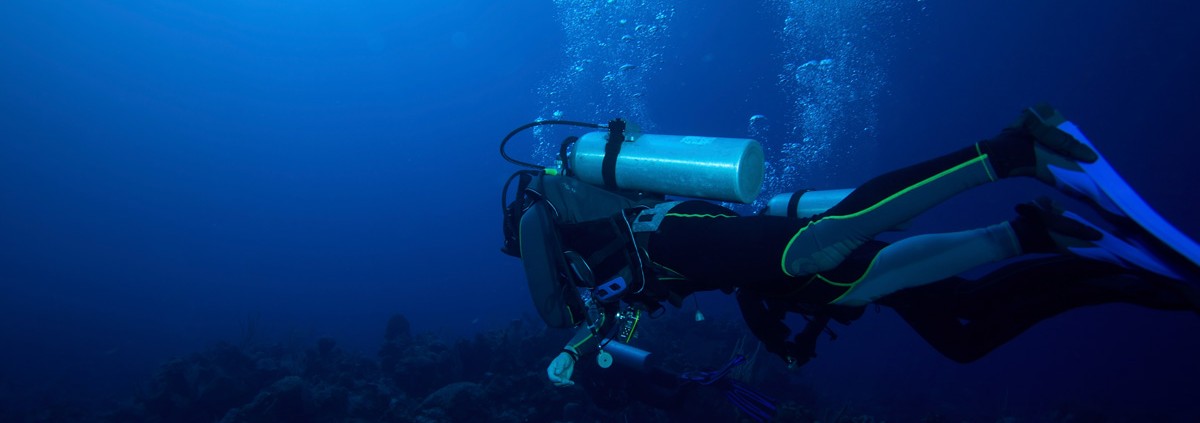 world class deep scuba diving over beautiful coral reef