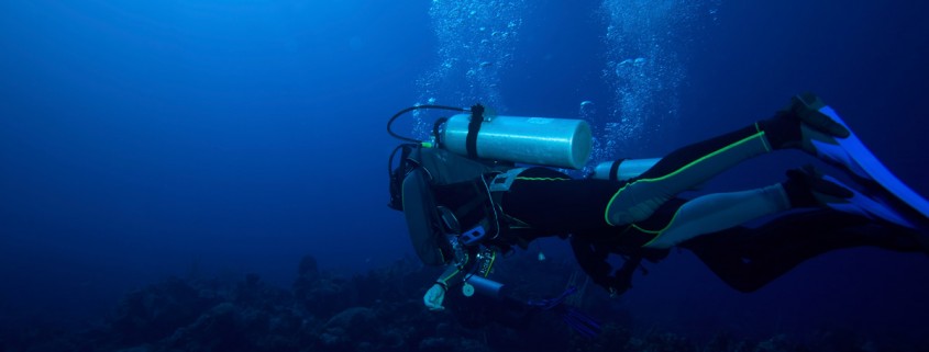 world class deep scuba diving over beautiful coral reef